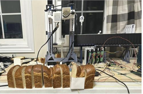 Breadbot prototype cutting bread